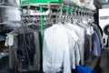 Clothes in plastic bags hanging at dry-cleaning Royalty Free Stock Photo