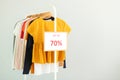 Clothes on the rail and a sale sign. Final sale, discounts Royalty Free Stock Photo