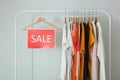 Clothes on the rail and a sale sign. Final sale, discounts Royalty Free Stock Photo