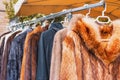 Clothes for sale for winter season hanging on a rack at outdoor flea market. Royalty Free Stock Photo