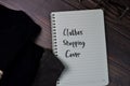 Clothes Shopping Costs text write on a book  wooden table Royalty Free Stock Photo