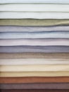 Clothes stack. Bright colourful fabric of beige colours