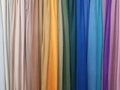 Clothes stack. Bright colourful rainbow fabric