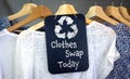 Clothes Swap and recycle clothes icon on chalk board with hanging shirts to swap, sustainable fashion and zero waste Royalty Free Stock Photo