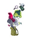 Clothes and various travel accessories flying out of a green backpack, isolated on a white background Royalty Free Stock Photo