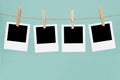 Clothesline with empty picture frames and clothespins on a blue background