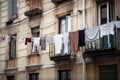 clothesline with laundry hanging out a window in the city