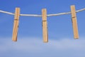 Clothesline and pegs on blue sky background Royalty Free Stock Photo