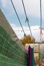 A clothespin hangs on the washing line. A rope with clean linen and clothes outdoors on the day of the laundry. Against the Royalty Free Stock Photo