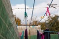 A clothespin hangs on the washing line. A rope with clean linen and clothes outdoors on the day of the laundry. Against the Royalty Free Stock Photo