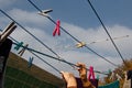 A clothespin hangs on the washing line. A rope with clean linen and clothes outdoors on the day of the laundry. Against the Royalty Free Stock Photo