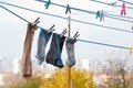 A clothespin hangs on the washing line. A rope with clean linen and clothes outdoors on the day of the laundry. Against the Royalty Free Stock Photo