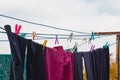 A clothespin hangs on the washing line. A rope with clean linen and clothes outdoors on the day of the laundry. Against the Royalty Free Stock Photo