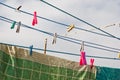 A clothespin hangs on the washing line. A rope with clean linen and clothes outdoors on the day of the laundry. Against the Royalty Free Stock Photo