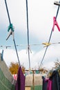 A clothespin hangs on the washing line. A rope with clean linen and clothes outdoors on the day of the laundry. Against the Royalty Free Stock Photo