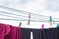 A clothespin hangs on the washing line. A rope with clean linen and clothes outdoors on the day of the laundry. Against the Royalty Free Stock Photo