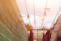 A clothespin hangs on the washing line. A rope with clean linen and clothes outdoors on the day of the laundry. Against the Royalty Free Stock Photo