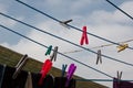 A clothespin hangs on the washing line. A rope with clean linen and clothes outdoors on the day of the laundry. Against the Royalty Free Stock Photo