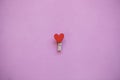 Clothespin with a heart on a pink background in a minimal style Royalty Free Stock Photo