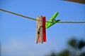 Clothespins in blue sky, white and red green colors