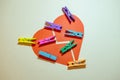 Clothespins on broken heart. Broken heart concept, or putting pieces back together. Place for your text Royalty Free Stock Photo