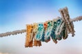 The clothespins on the clothesline are covered in frost. Frosty freshness