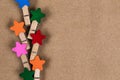 Clothespins with colorful stars laid out in a row on a cortical background with copy space for text Royalty Free Stock Photo