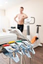 Clothespins of the ECG machine in the foreground. Athlete does a cardiac stress test and VO2 in a medical study Royalty Free Stock Photo