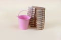 Clothespins and a small, pink bucket. Copy space - concept of cleaning, cleanliness, household chores Royalty Free Stock Photo