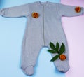 Clothing and accessories for newborns. Cotton baby jumpsuit decorated with flowers. Top view of children& x27;s clothing