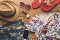 Clothing and accessories for women on wood floor for travel at h Royalty Free Stock Photo