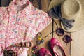 Clothing and accessories for women on wood floor for travel at h Royalty Free Stock Photo