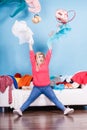 Woman sitting on messy couch throwing clothes Royalty Free Stock Photo