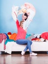 Woman sitting on messy couch throwing clothes Royalty Free Stock Photo