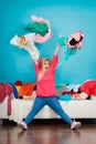 Woman sitting on messy couch throwing clothes Royalty Free Stock Photo