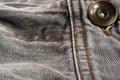 clothing items stonewashed cotton fabric texture with seams, clasps, buttons and rivets, macro