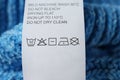 Clothing label with care symbols on sweater, closeup view