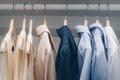 Clothing men shirt and female dress hanging on the wardrobe in the family dressing room at home. cool tone and film style photo Royalty Free Stock Photo