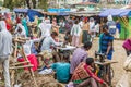 Clothing menders with vintage manual sewing machines at the market in Debark