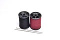 The clothing repair kit consists of black and dark red thread Royalty Free Stock Photo