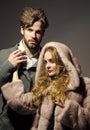 Clothing sale. Boyfriend hold hand of girlfriend in mink fur coat