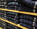 Clothing stacked neatly on the shelf in fashion shop Royalty Free Stock Photo