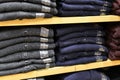 Clothing stacked neatly on the shelf in fashion shop Royalty Free Stock Photo