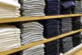 Clothing stacked neatly on the shelf in fashion shop Royalty Free Stock Photo