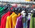 clothing stall with many clothes hanging on racks selling both new and used vintage clothes Royalty Free Stock Photo