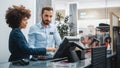 Clothing Store Checkout Cashier Counter: Female Retail Sales Manager Explaining to New Male Royalty Free Stock Photo