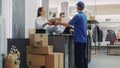 Clothing Store Checkout Cashier Counter: Retail Sales Managers Pack and Give Package Delivery