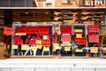 A clothing store in China, with promotions and clearance sale announcements plastered on the door, claiming to be closing soon