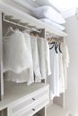 Cloths hanging in wooden wardrobe at home Royalty Free Stock Photo