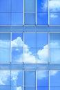 Cloud and blue sky reflection on surface of glass modern building wall Royalty Free Stock Photo